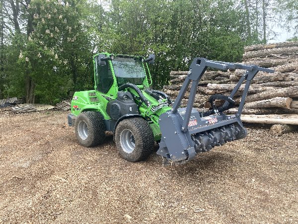 Brush mowing vehicle for lot clearing.