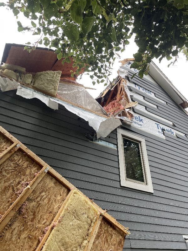 Storm damage clean-up after a tree falls onto a home.