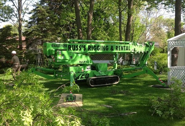 Russ's Tree Service Spider Lift machine at a tree trimming job.