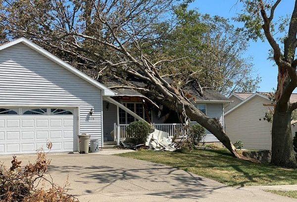 Storm damage clean-up after a tree falls onto a home.