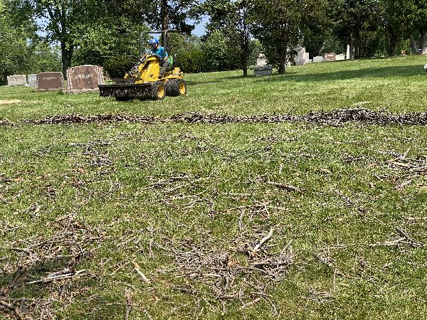 Sweeper vehicle doing lawn clean-up.